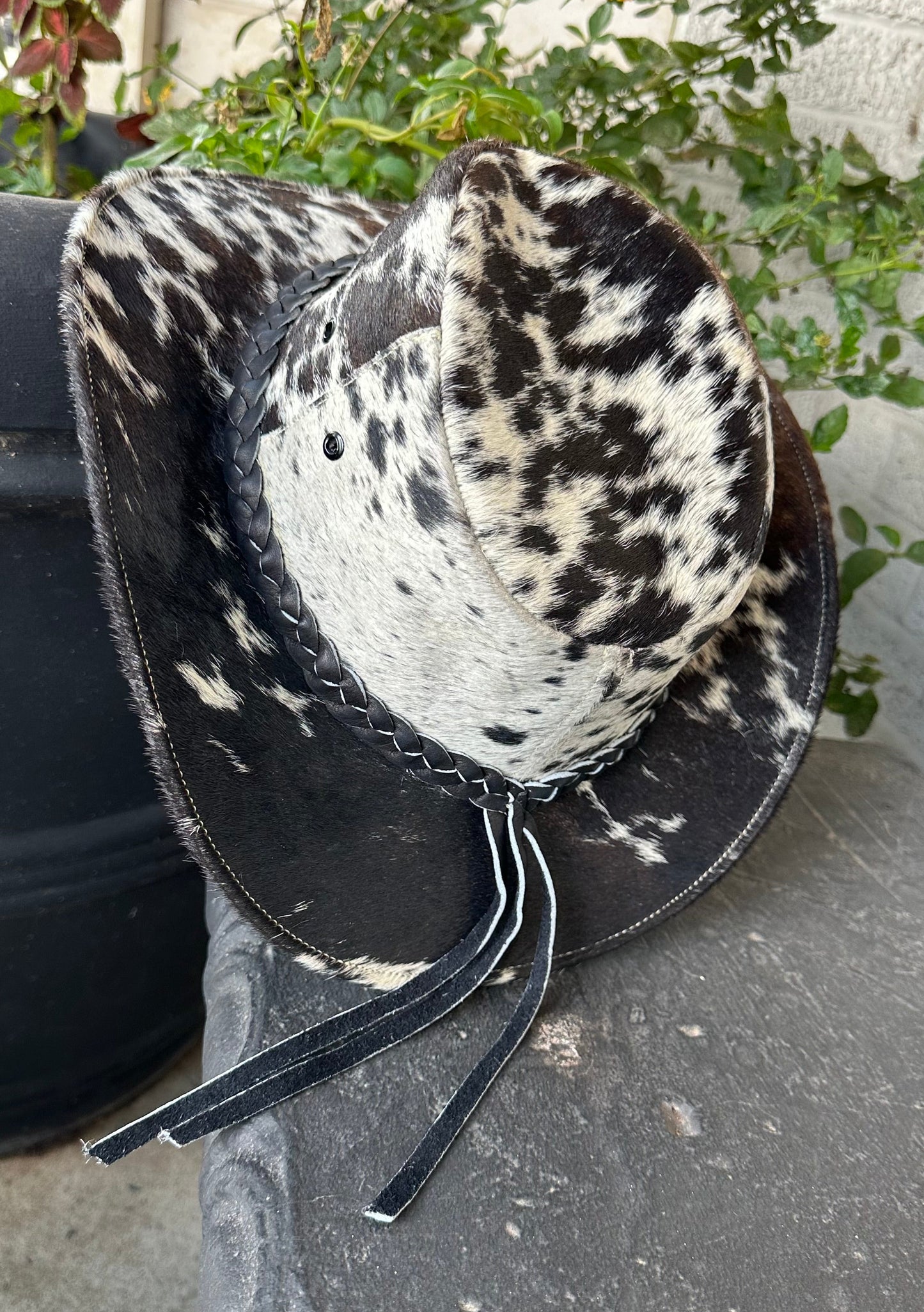 Goat hide Cowboy hat with black and white pattern on a concrete surface